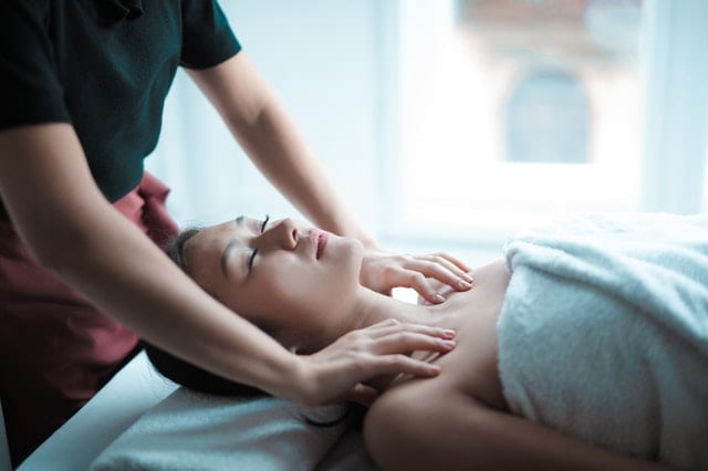 Photo of a woman face-up on a massage table. This is the best position from which to address flexion dysfunction.